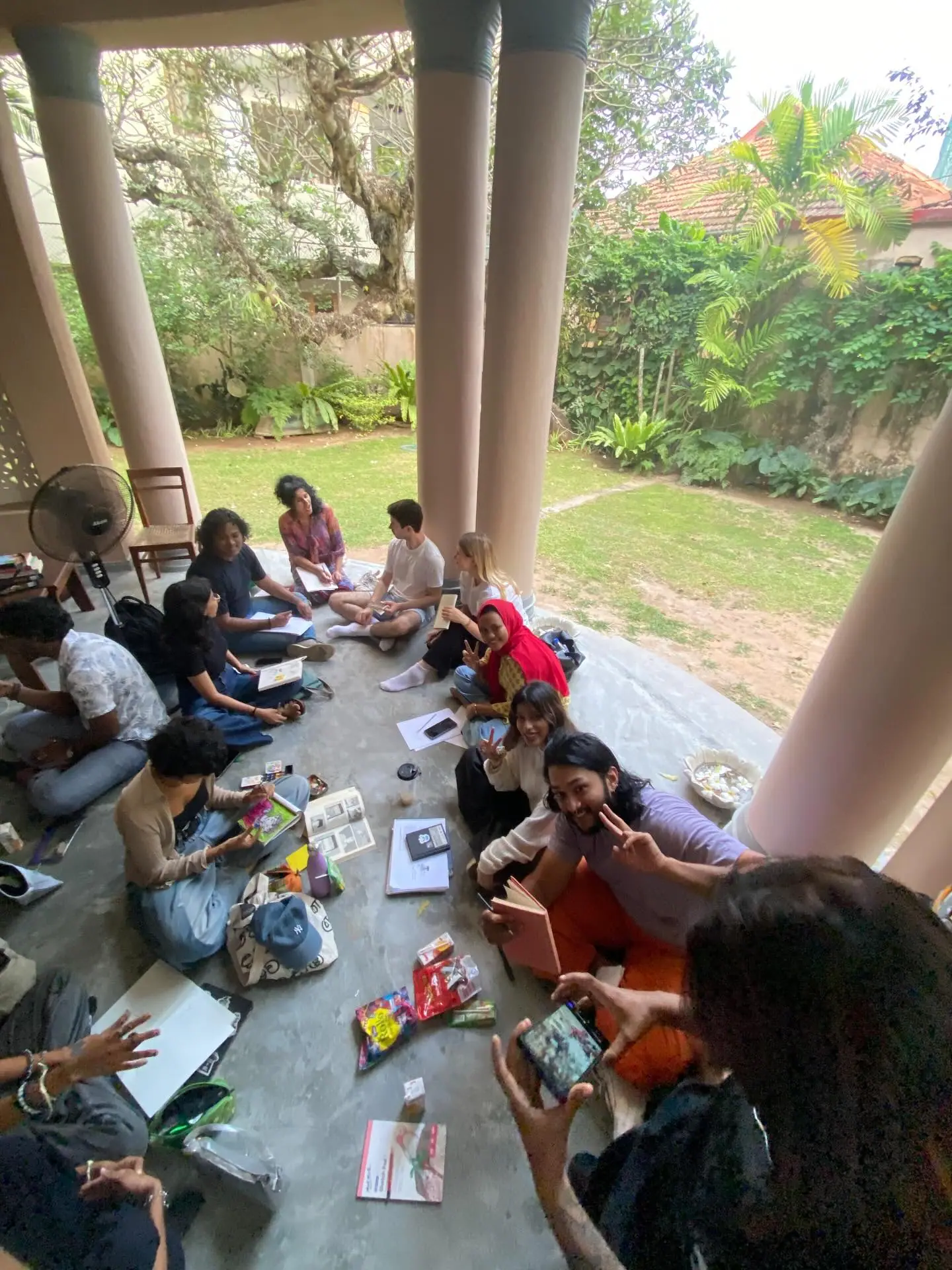 People sketching on a garden veranda at Lakmahal