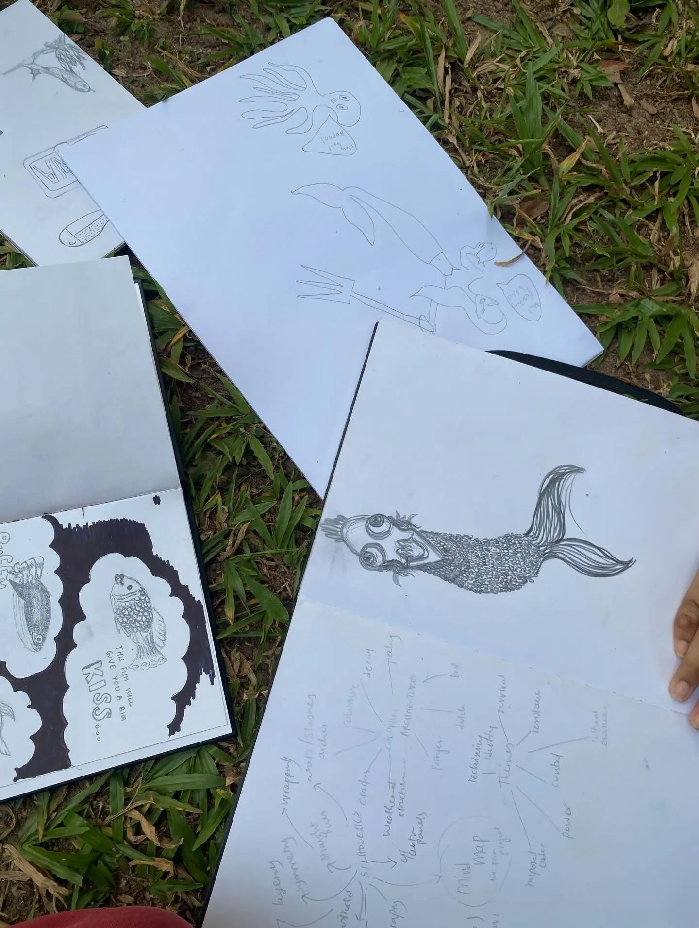 Outdoor sketchbooks on the grass at Viharamahadevi Park